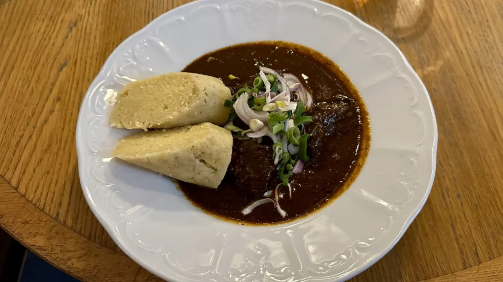 Traditional beef goulash with potato dumplings Restaurace Mincovna Prague